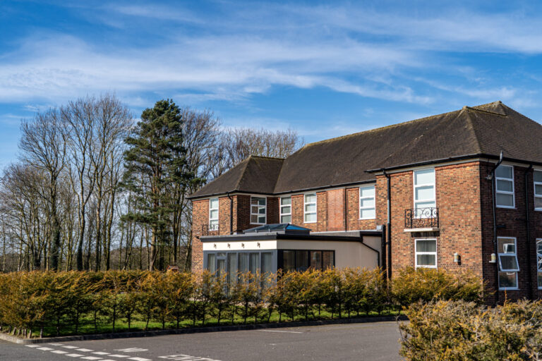 A red brick building with a porch