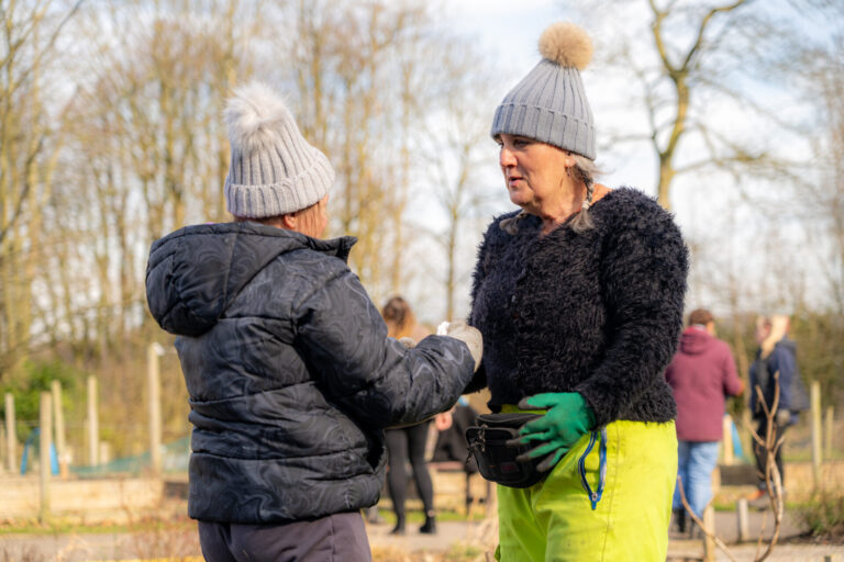 Two women talking to each other while working at landbase
