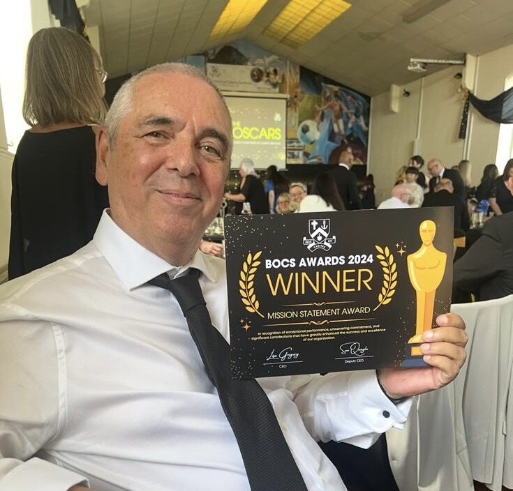 Two women collaborating, holding each others' arms