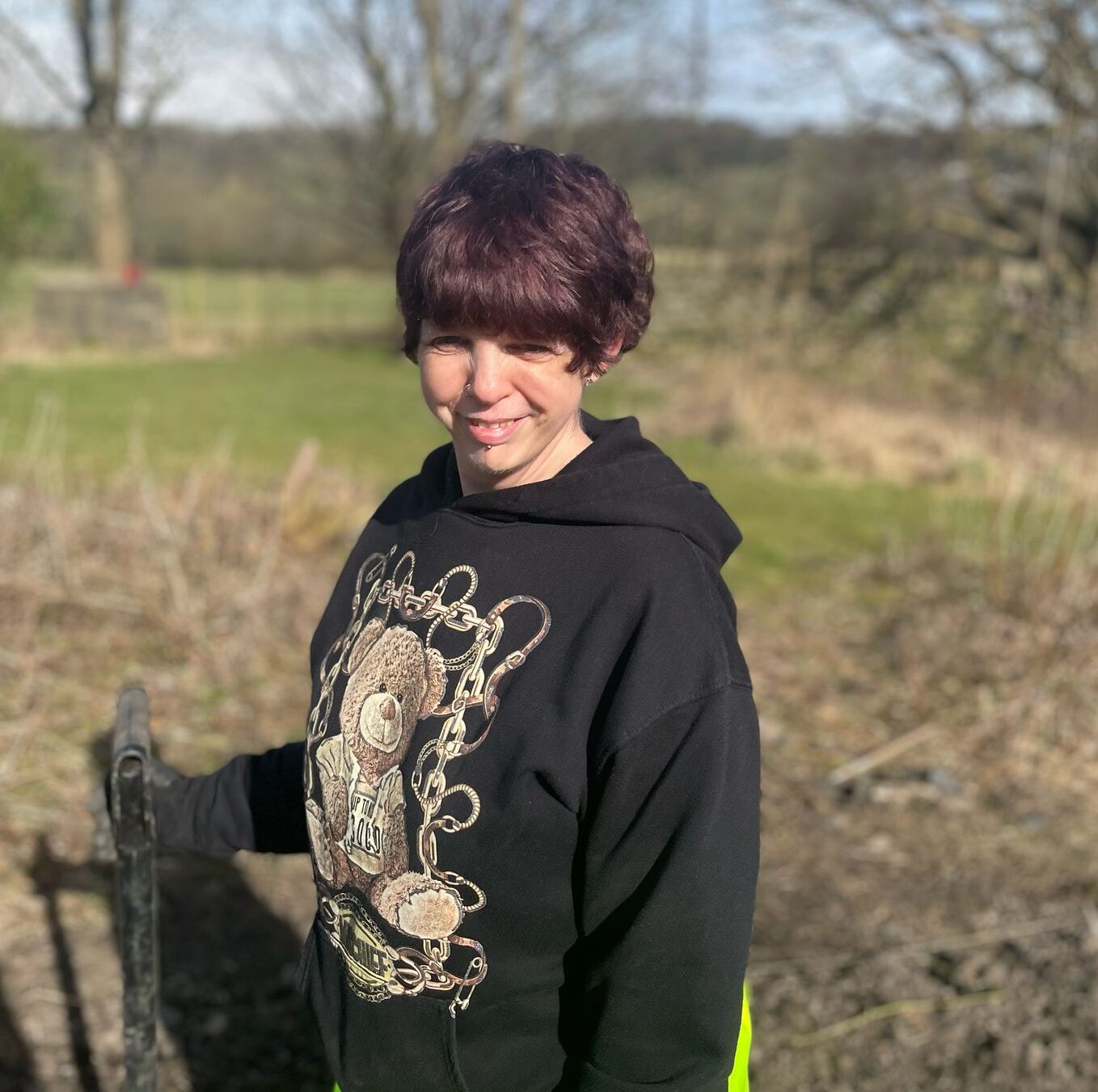 Young person standing outdoors in casual clothing