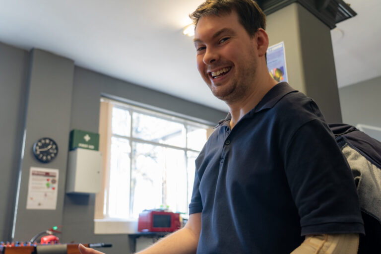 Man smiling in a kitchen during a support activity