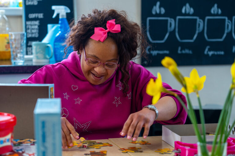 A woman working on a jigsaw puzzle