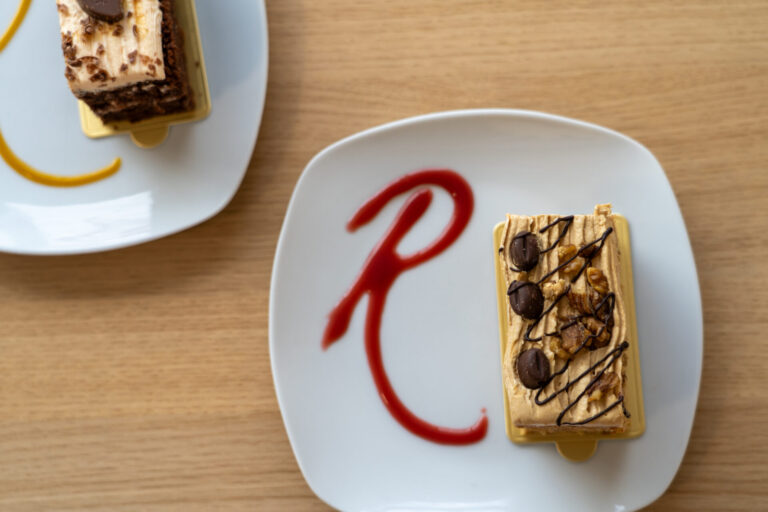 Dessert plate with a slice of cake decorated with chocolate drizzle