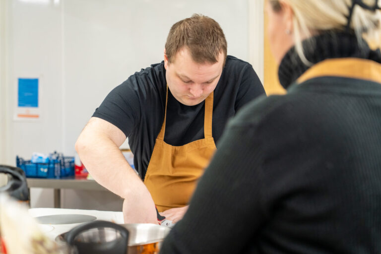 Man at food based enterprise prepping food
