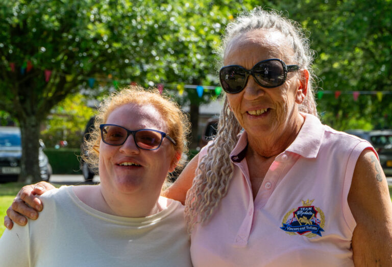 two women smiling on a sunny day